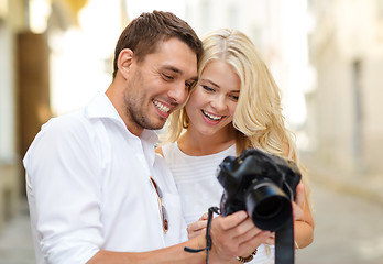 Image showing smiling couple with photo camera