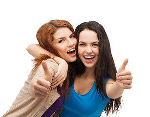 Image showing two smiling girls showing thumbs up