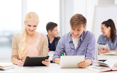 Image showing two smiling students with tablet pc at school