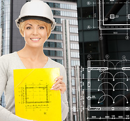 Image showing female contractor in white helmet with files