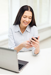 Image showing smiling businesswoman or student with laptop