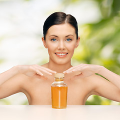 Image showing beautiful woman with oil bottle