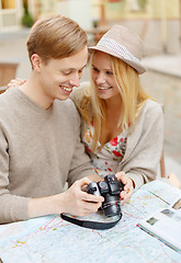 Image showing smiling couple with photo camera