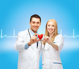 Image showing smiling doctors cardiologists with heart