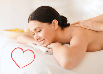 Image showing smiling woman in spa salon getting massage