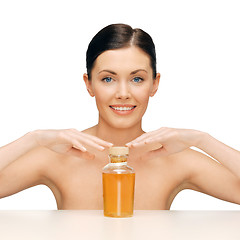 Image showing beautiful woman with oil bottle