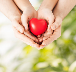 Image showing woman and man hands with heart