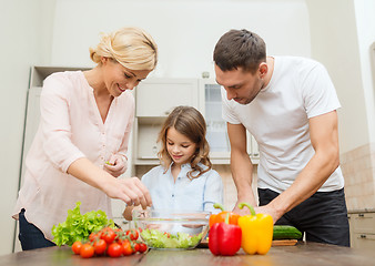 Image showing happy family making dinner in kitchen