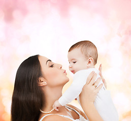 Image showing happy mother kissing her child