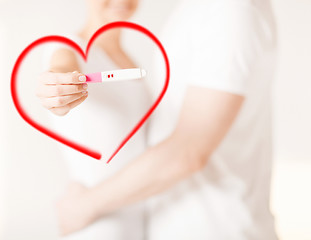 Image showing woman and man hands with pregnancy test