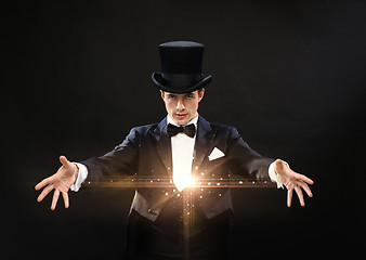 Image showing magician in top hat showing trick