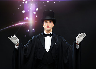 Image showing magician in top hat with magic wand showing trick