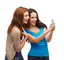 Image showing two smiling teenagers with smartphone