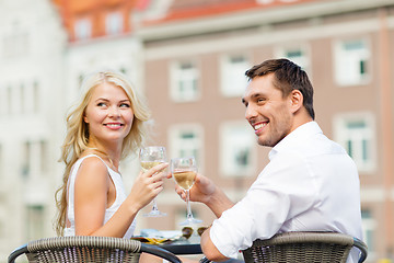 Image showing smiling couple drinking wine in cafe