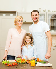 Image showing happy family making dinner in kitchen