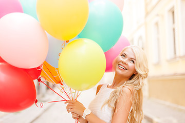 Image showing smiling woman with colorful balloons