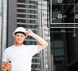 Image showing male architect in white helmet with blueprint