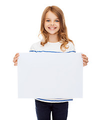 Image showing smiling little child holding blank white paper