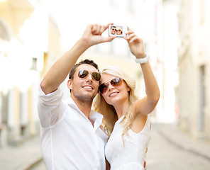 Image showing travelling couple taking photo picture with camera