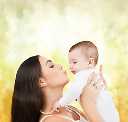 Image showing happy mother kissing her child