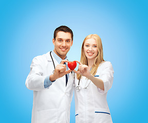 Image showing smiling doctors cardiologists with heart