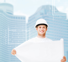 Image showing male architect in white helmet with blueprint