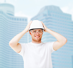 Image showing male architect in helmet with safety glasses