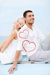 Image showing couple sitting on boat at sea side