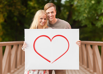 Image showing romantic couple with white board and heart on it