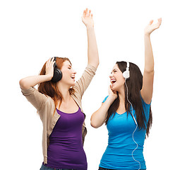 Image showing two laughing girls with headphones dancing