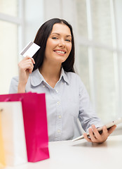 Image showing smiling woman with blank screen tablet pc