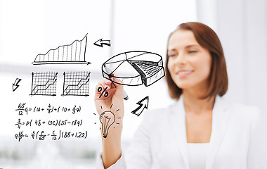 Image showing businesswoman writing chart on virtual screen