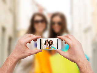 Image showing close up of hands taking picture with smartphone