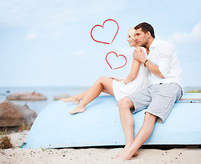 Image showing couple sitting on boat at sea side