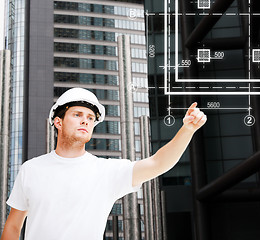 Image showing male architect pointing at blueprint