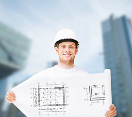 Image showing male architect in white helmet with blueprint