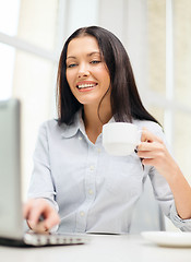 Image showing smiling businesswoman or student with laptop