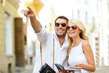 Image showing couple with map, camera and travellers guide