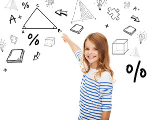 Image showing girl pointing to triangle on virtual screen