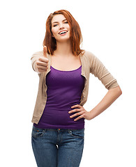 Image showing smiling girl in casual clothes showing thumbs up