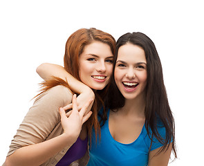 Image showing two laughing girls hugging