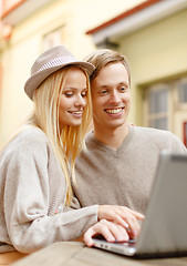 Image showing smiling couple with laptop computer in cafe