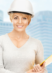 Image showing female contractor in helmet with bluepring