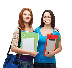 Image showing two smiling students with bag, folders and tablet