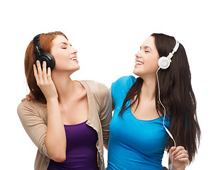 Image showing two smiling teenagers with headphones