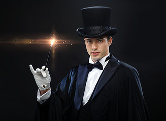 Image showing magician in top hat with magic wand showing trick