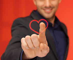 Image showing handsome man in suit pressing virtual button