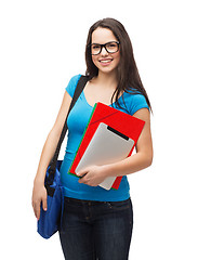 Image showing smiling student with bag, folders and tablet pc