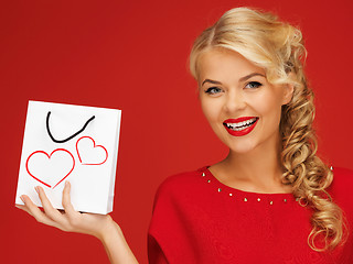 Image showing lovely woman in red dress with shopping bag