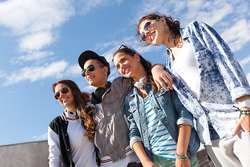 Image showing smiling teenagers in sunglasses hanging outside